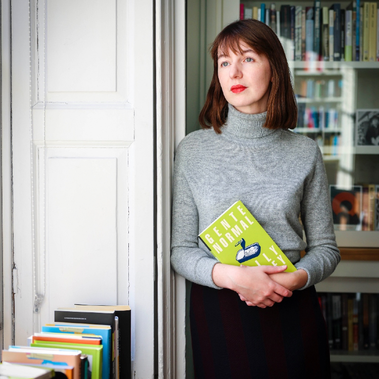 Author Sally Rooney pictured holding one of her books in Trinity Centre for Literary and Cultural Translation