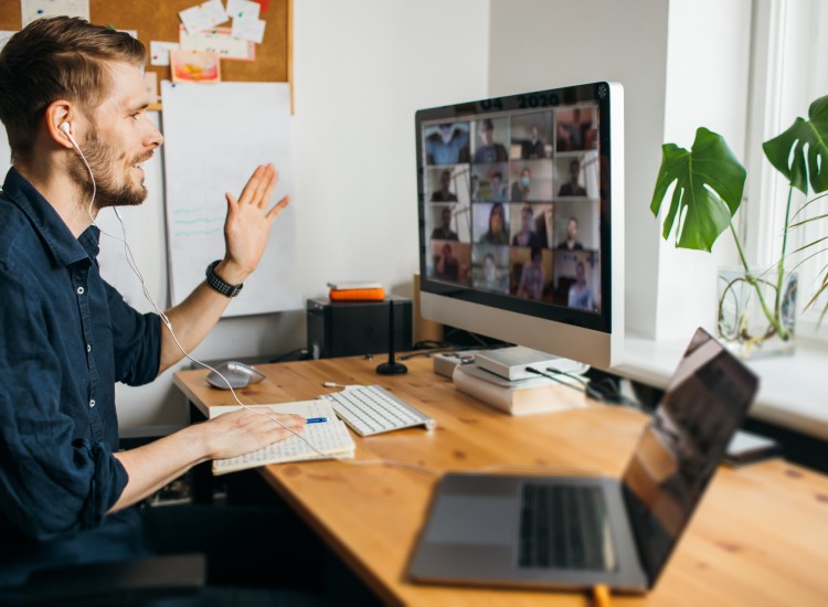 Man at desk in online meeting