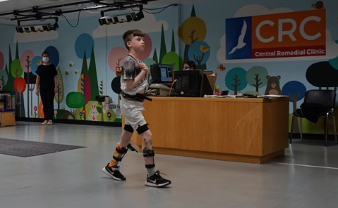 A child walking while having their gait analysed.